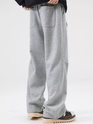 Grey casual loose-fit sweatpants with pockets and drawstring detail.