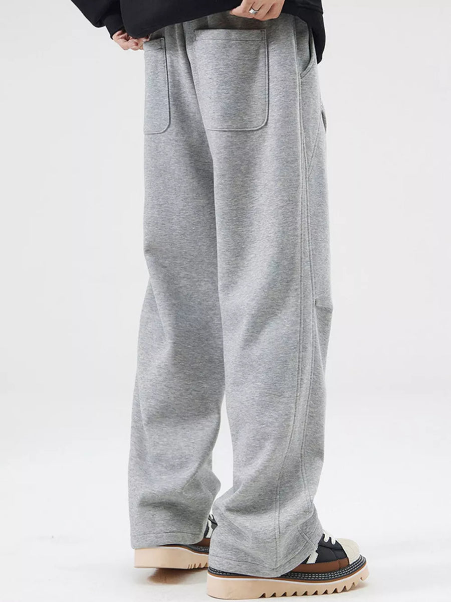 Grey casual loose-fit sweatpants with pockets and drawstring detail.