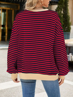 Striped crew neck sweatshirt in red and navy with a tan hem and cuffs.