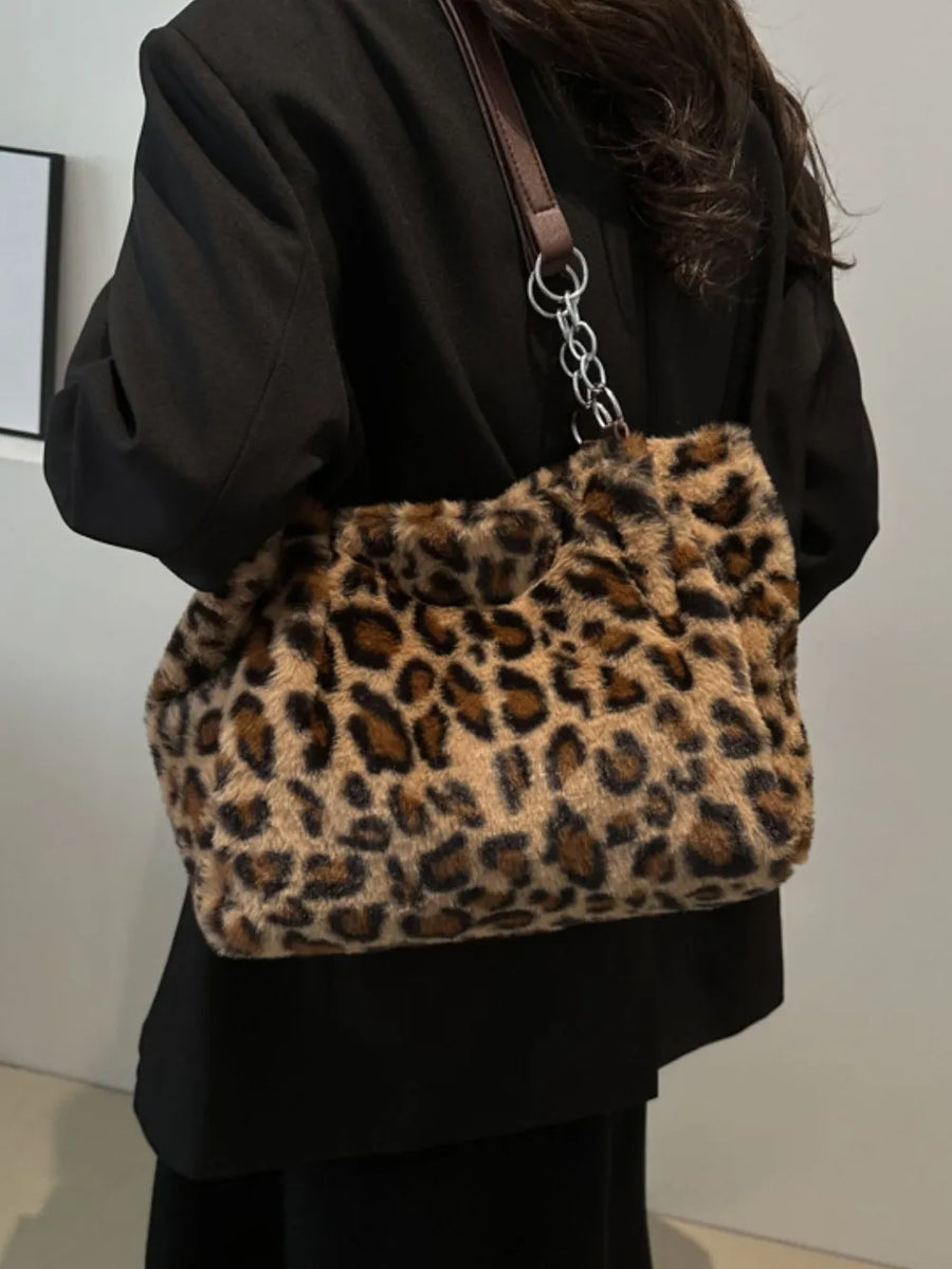 Leopard print plush tote bag with chain handle detail.