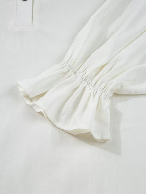 White linen shirt with ruffled cuffs and a button detail