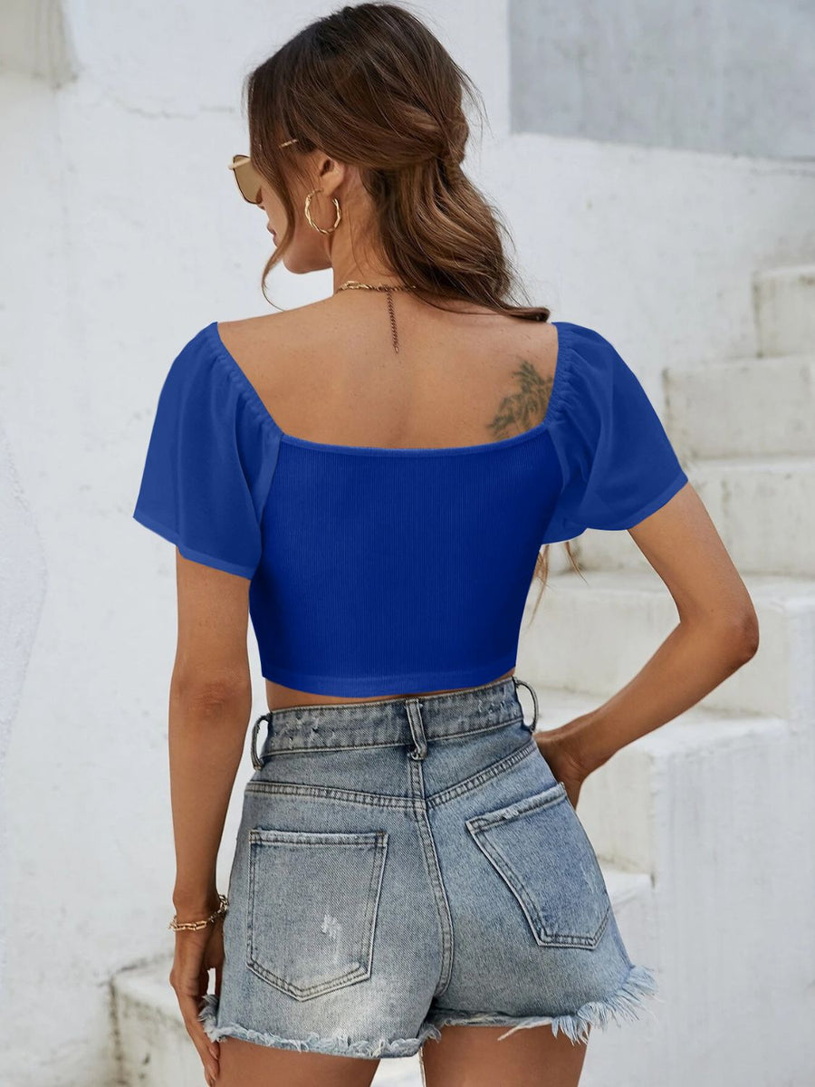 Royal blue ribbed crop top with chiffon sleeves and square neckline.