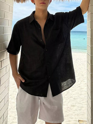 Black short sleeve buttoned casual shirt with chest pocket, relaxed fit.