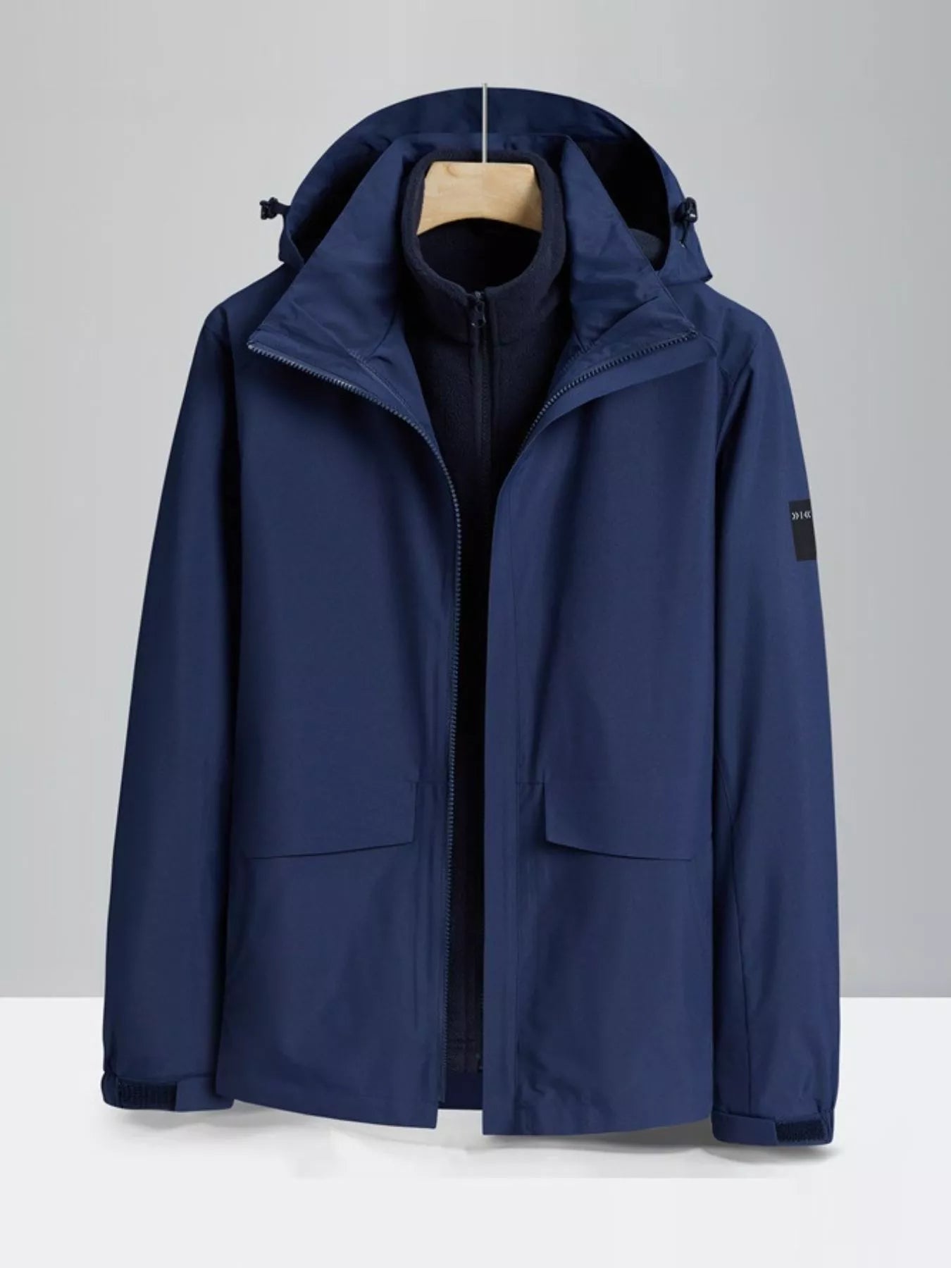 Men's dark blue hooded waterproof jacket with zip and two front pockets.