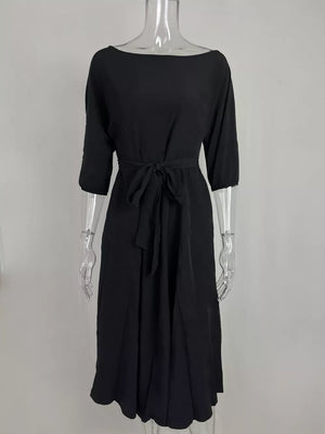 Black off-the-shoulder belted midi dress with 3/4 sleeves and a tie waist.
