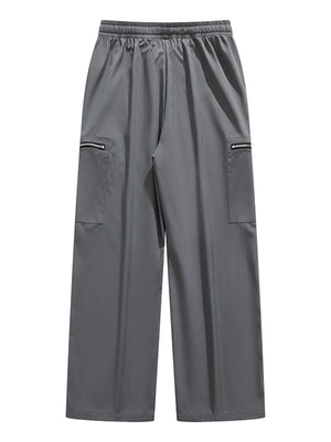 Plus-size dark gray cargo pants with drawstring waist and zippered pockets.