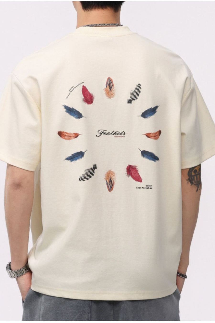Cream cotton blend crew neck t-shirt with a circular feather print on the back.