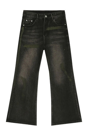 Dark wash bootcut jeans with green paint-like accents and a faded effect.
