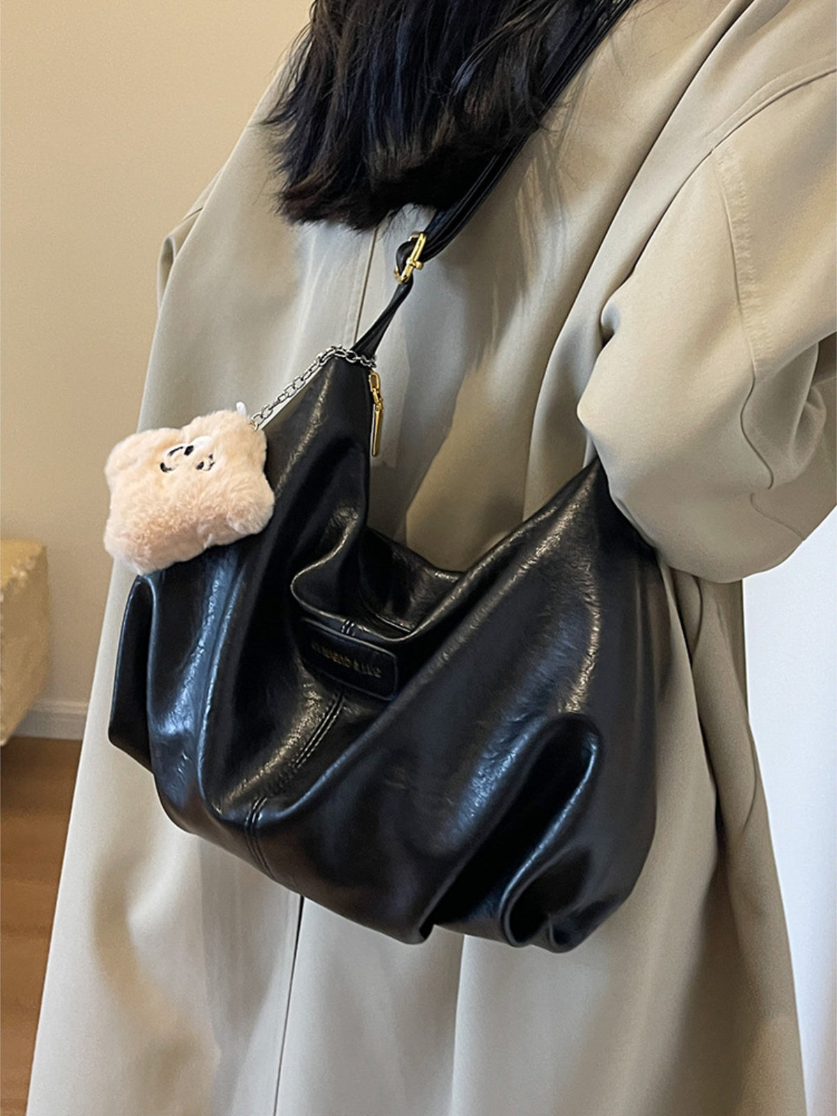 Medium black pu leather crossbody bag with chain detail and fluffy charm