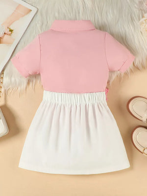 Toddler pink polo shirt and white skirt set with floral appliqué detail
