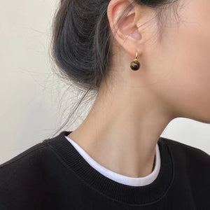 golden earrings featuring ball drop and natural stone pattern