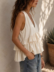 White ruffled V-neck tank top with layered tiers and a flowy hem.