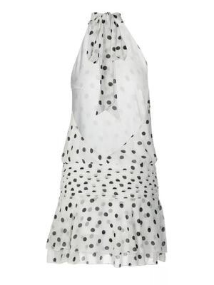 White polka dot halter neck mini dress with ruched waist and tie detail.