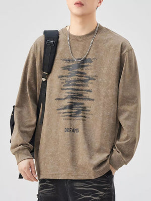 Brown oversized long-sleeve tee with graphic text print and "DREAMS" graphic.
