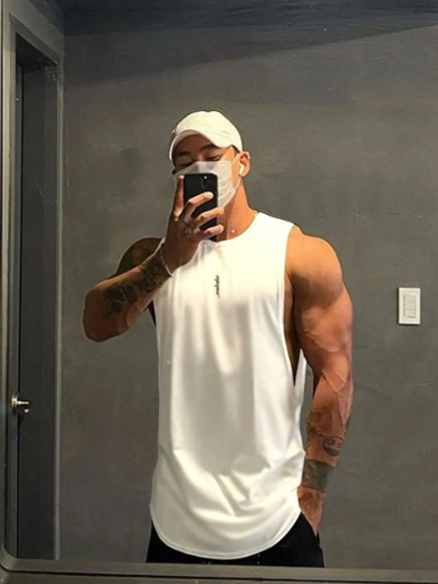 White performance cut tank top with a rounded hem and subtle logo detail.