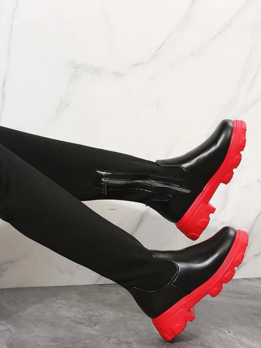 Black knit-top over-the-knee boots with red platform soles and side zipper.
