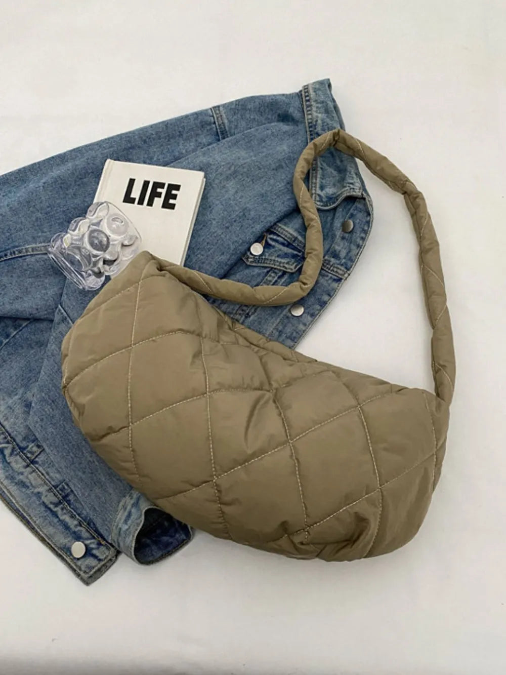 Khaki quilted crossbody bag with a puffy design and a single strap.