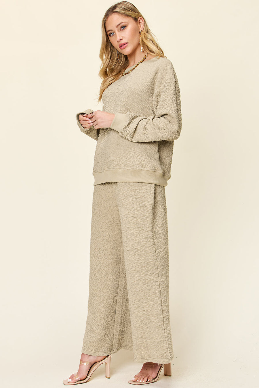 Textured loungewear set in tan with crewneck sweatshirt and wide leg pants.