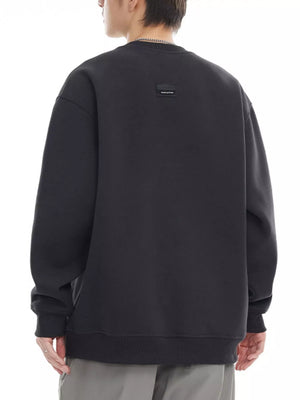 Black oversized cotton crew-neck sweatshirt with a small black tag detail on the back.