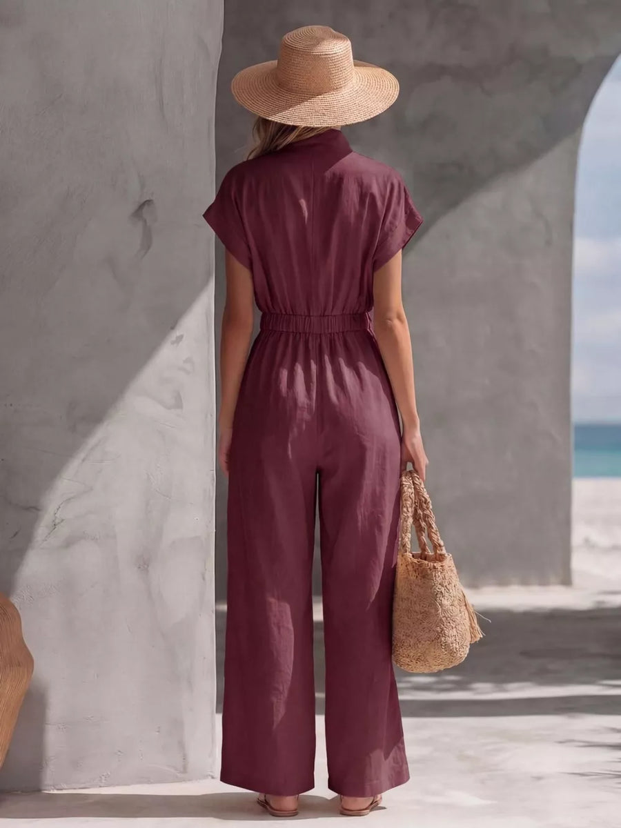 Burgundy wide-leg maternity jumpsuit with elastic waist and short sleeves.