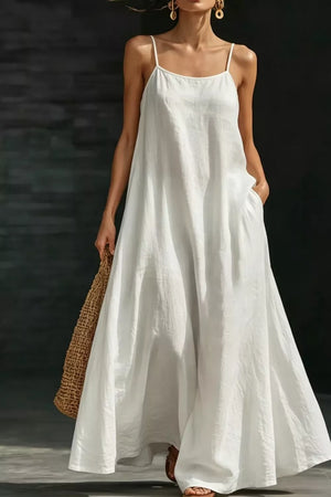 White A-line maxi dress with spaghetti straps and pockets, flowing casual style