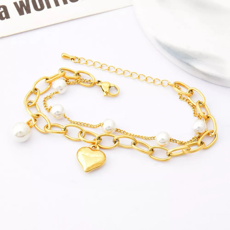 Synthetic Pearl, 18K Gold-Plated, Titanium Steel Care instructions: Avoid wearin bracelet in ivory with jewelry silhouette