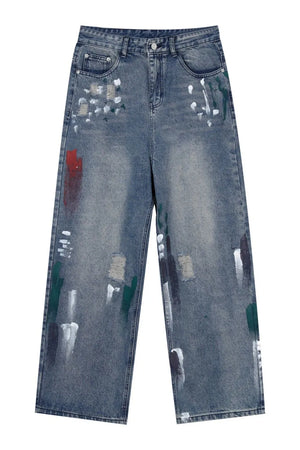 Medium wash baggy jeans with artistic paint splatters and distressed details.