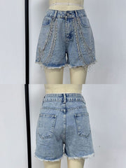 Sky blue denim shorts with rhinestone chain embellishments and frayed hem.