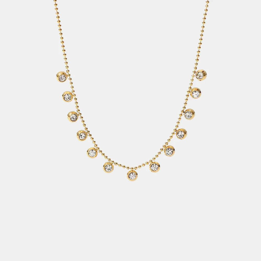 Gold-plated necklace with dangling pavé charms on a beaded chain
