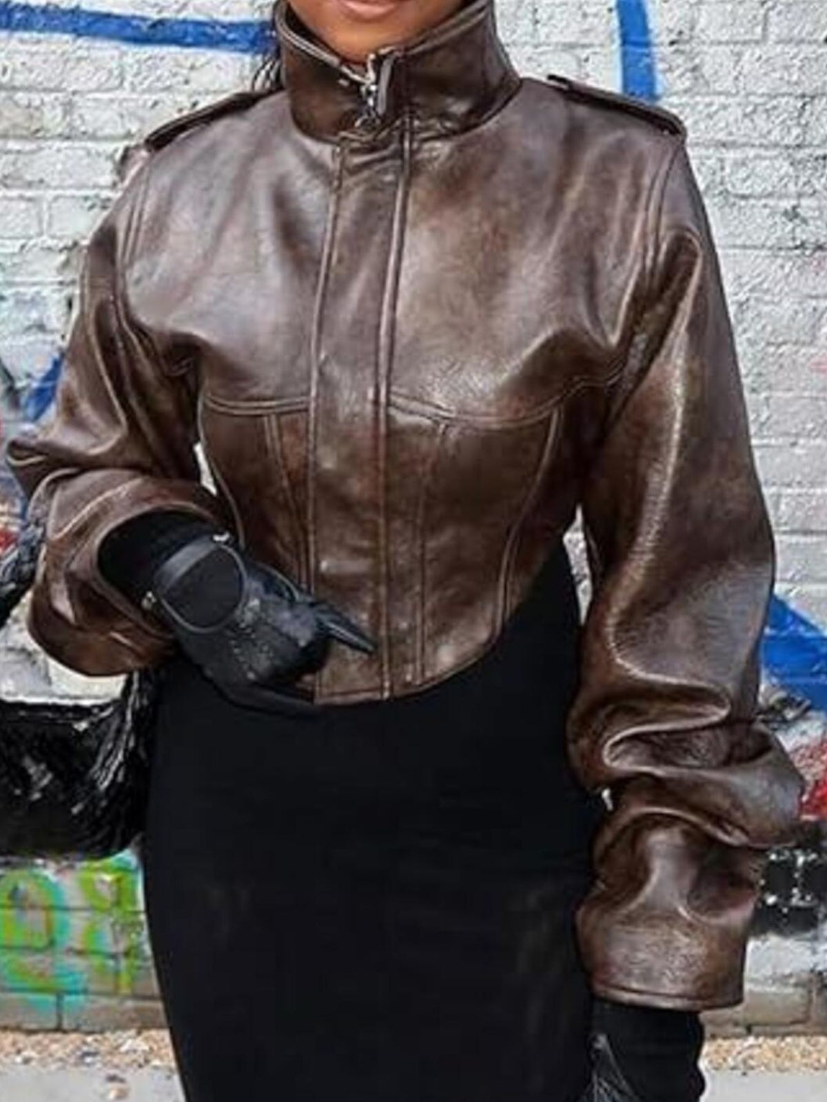Brown distressed leather jacket with a high collar and slim fit.