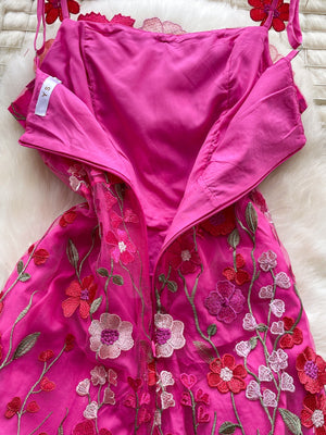 Embroidered floral mini dress in bright pink with sheer overlay and colorful flower appliques.