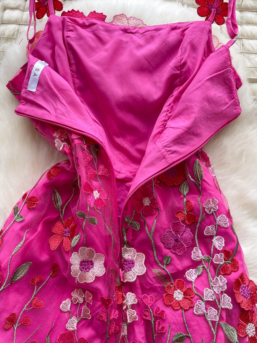 Embroidered floral mini dress in bright pink with sheer overlay and colorful flower appliques.