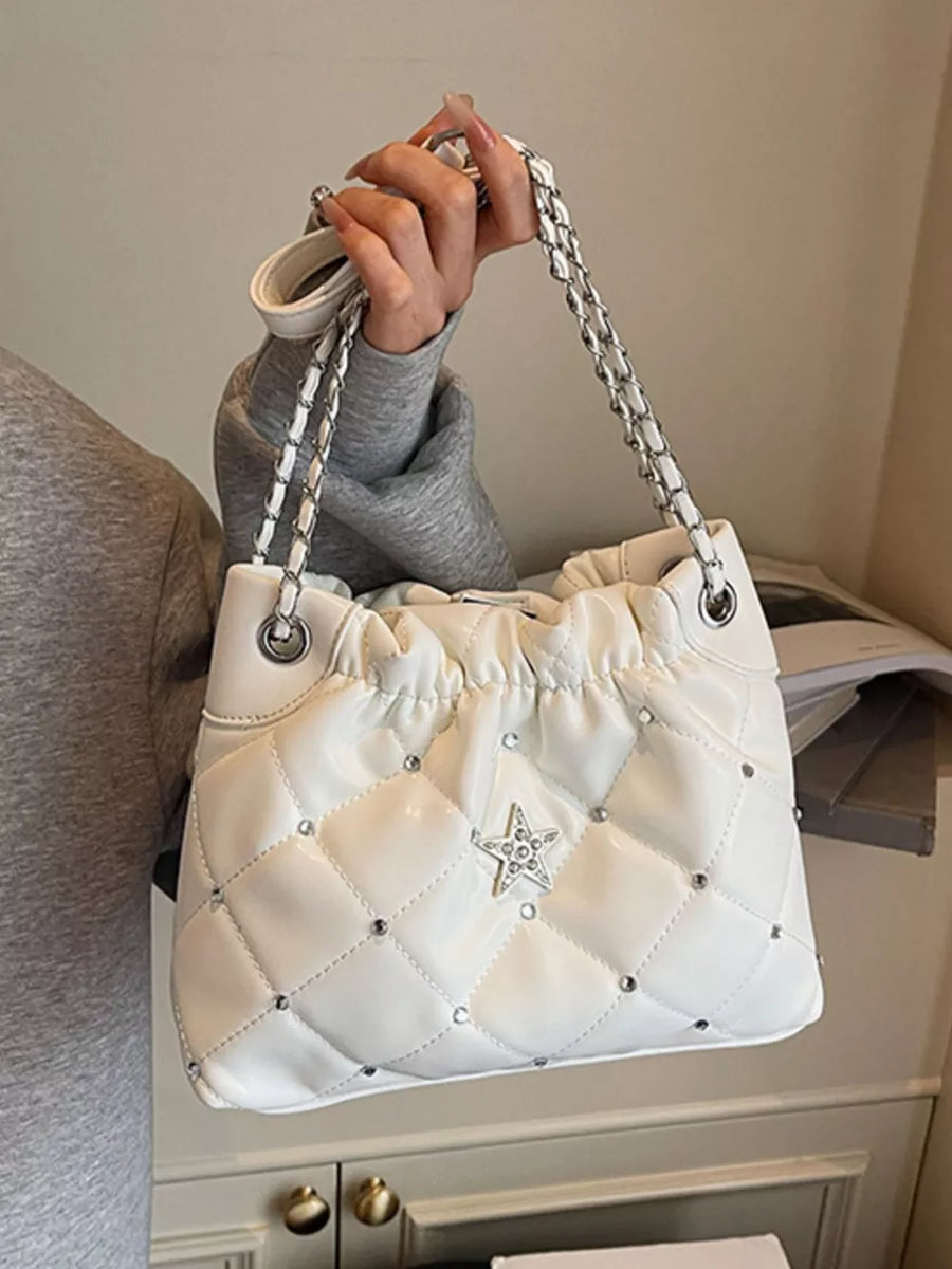 White quilted shoulder bag with diamond pattern, rhinestone star detail, and chain strap.
