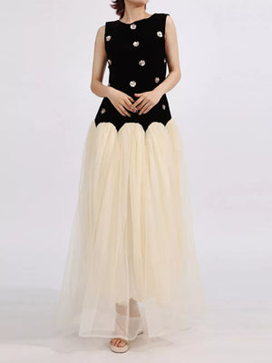 Black velvet sleeveless dress with floral embellishments and a cream tulle maxi skirt.