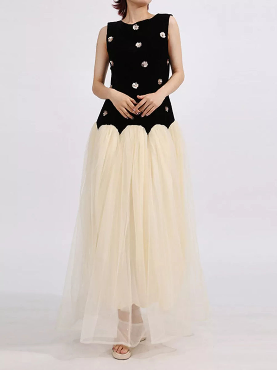 Black velvet sleeveless dress with floral embellishments and a cream tulle maxi skirt.