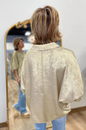 Beige textured blouse with Johnny collar and elastic cuffs, shown from the back.