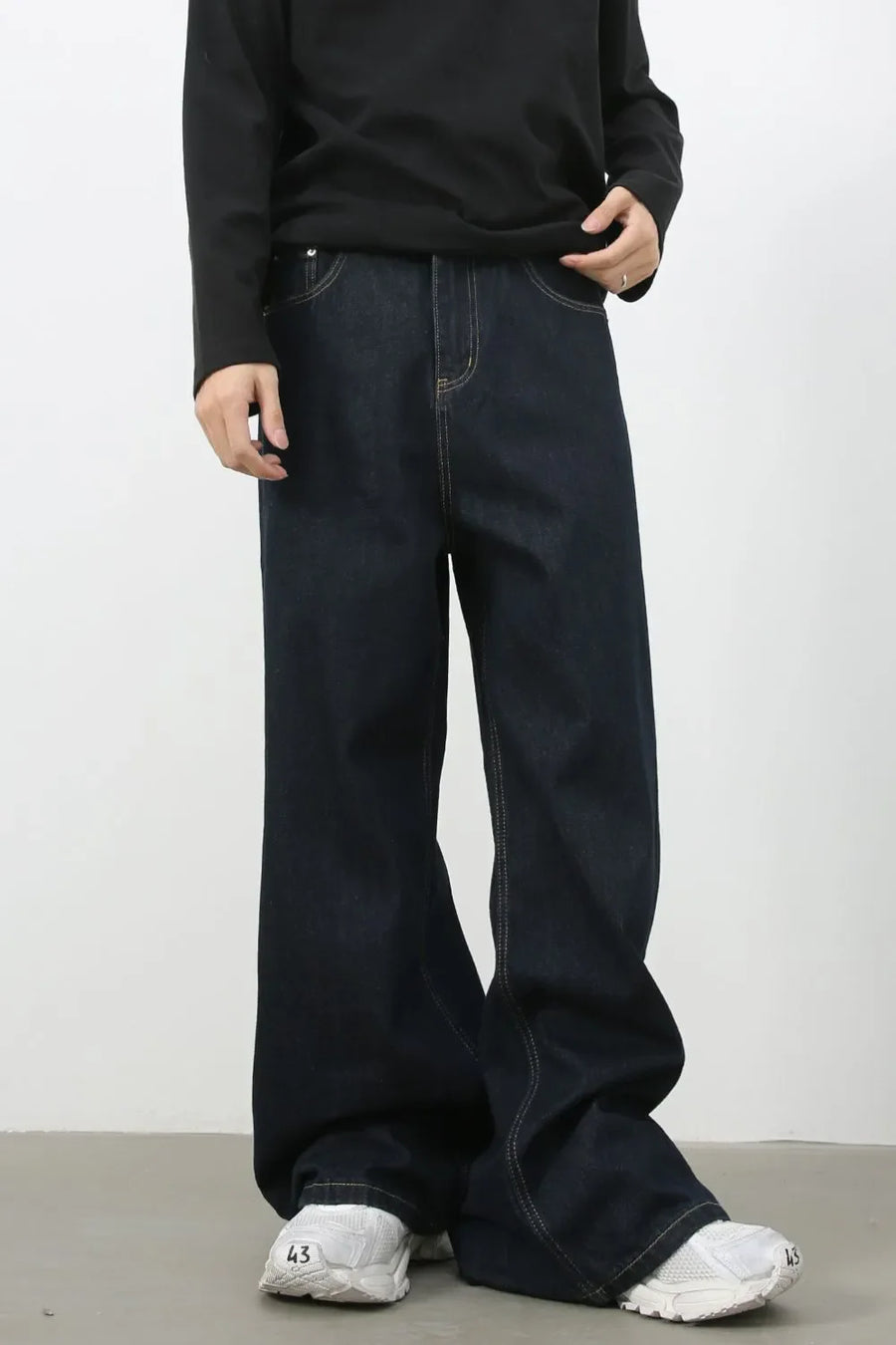 Exaggerated wide leg dark wash denim jeans with contrast stitching.