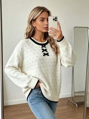 black pullover sweater featuring bow and polka dot