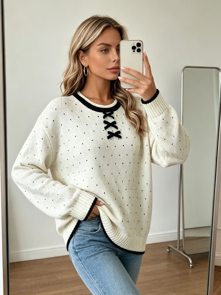 black pullover sweater featuring bow and polka dot