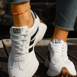 black sneakers featuring round toe and color-block
