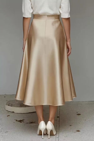 Lustrous midi skirt in champagne with an A-line cut and hidden pockets.