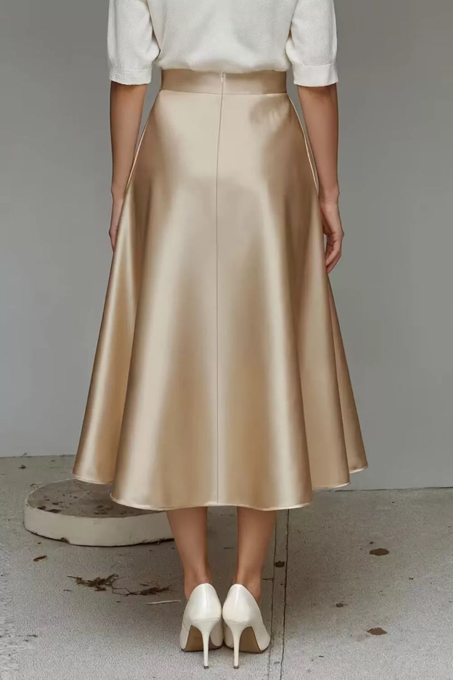 Lustrous midi skirt in champagne with an A-line cut and hidden pockets.
