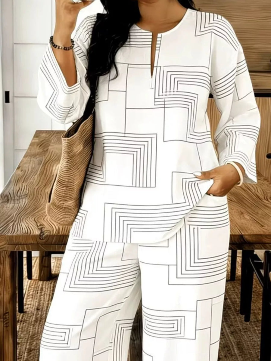 White geometric print two-piece set with split neck tunic and wide-leg pants.
