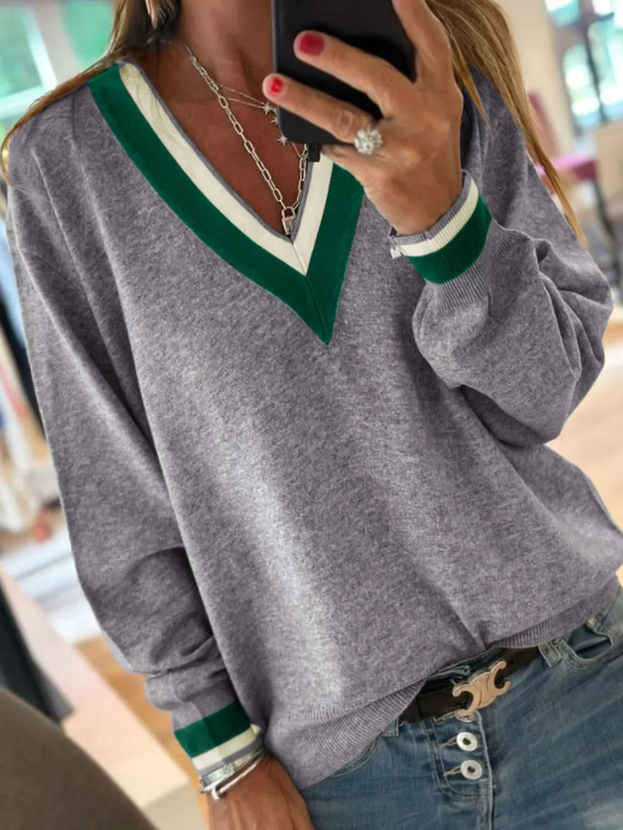Gray V-neck sweater with green and white stripe trim and ribbed cuffs.
