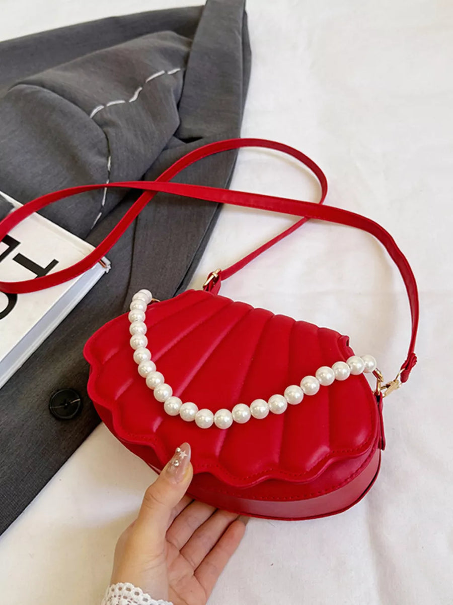 Red shell crossbody bag with pearl strap detail