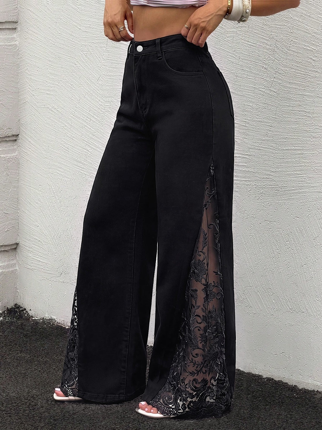 wide-leg jeans in black featuring lace and flared fit