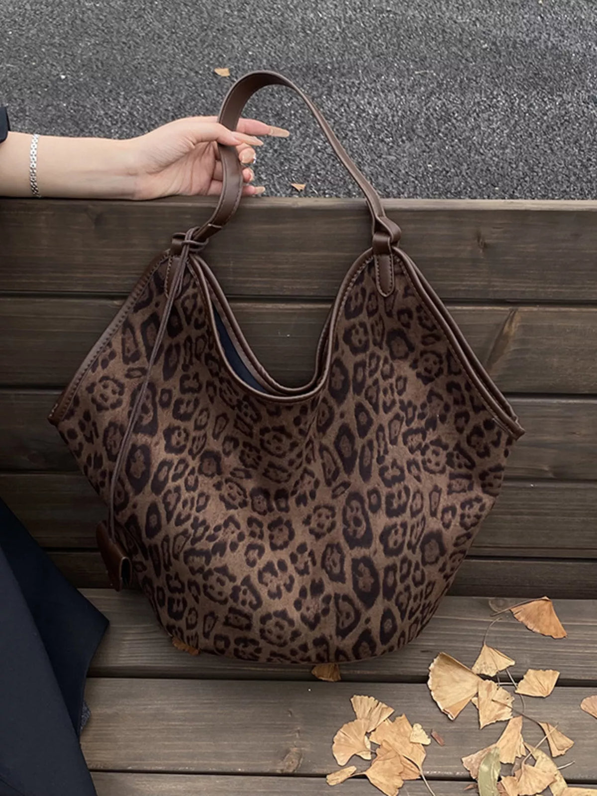 Chic leopard print tote bag in brown with leather straps and trim.