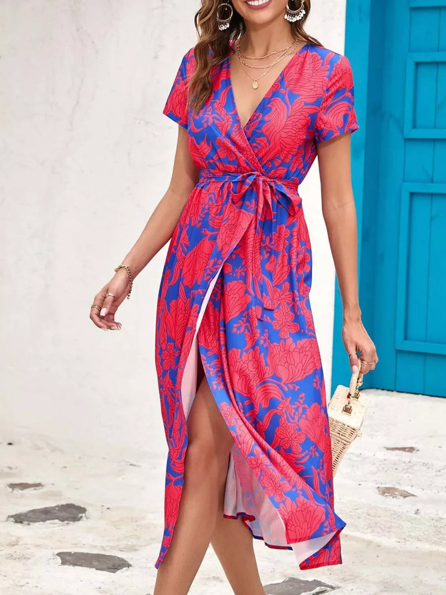 Wrap dress with blue and red floral print, short sleeves, v-neck, and tie waist.