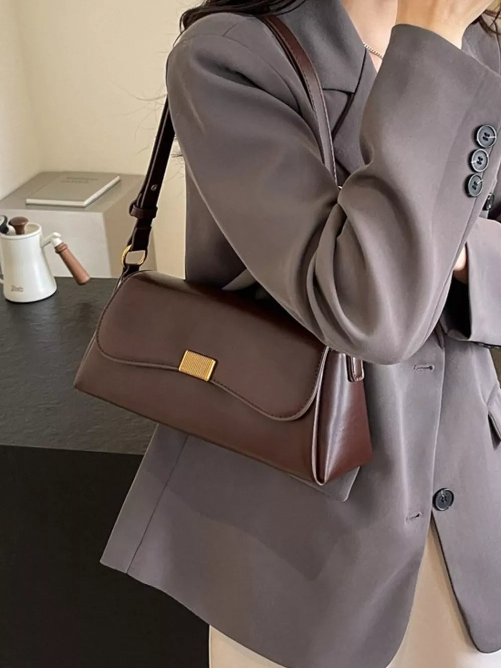 shoulder bag in dark brown with flap closure and small
