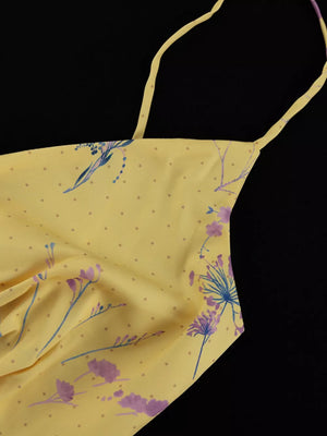 Yellow floral print slip dress with thin straps and a polka dot pattern.